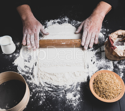 wooden rolling pin in male hands