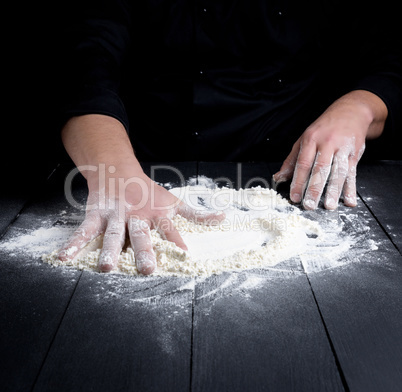 white wheat flour on a black wooden table