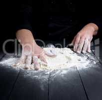 white wheat flour on a black wooden table