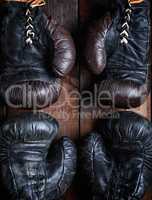 two pairs of leather old boxing gloves