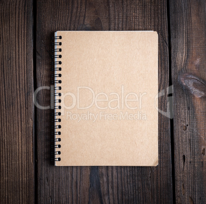 notebook on a black iron spring with brown empty sheets