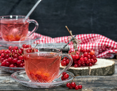 hot viburnum tea in a transparent cup with a handle