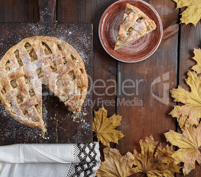 baked round apple pie and one cut piece on a plate