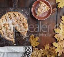 baked round apple pie and one cut piece on a plate