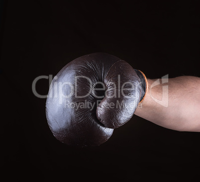 brown boxing glove dressed on man's hand