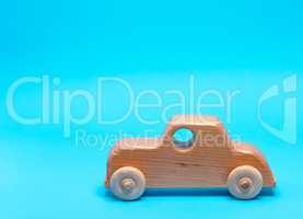 wooden childrens car on a blue background