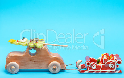 wooden children's car carries a caramel holiday spruce and pulls