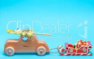 wooden children's car carries a caramel holiday spruce and pulls