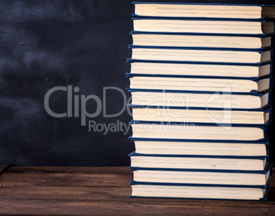 large stack of books in a blue cover