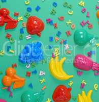 green background with childrens plastic toys