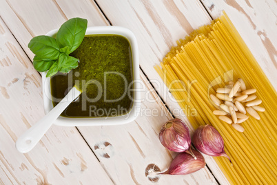 Closeup of pesto genovese and linguine pasta, pine nuts and garl