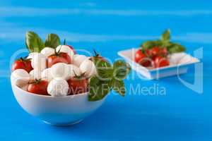 Fresh mozzarella, cherry tomatoes and basil in a bowl