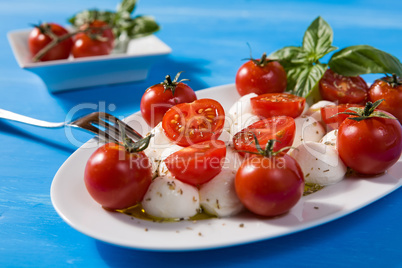 Closeup if Italian caprese with mozzarella, cherry tomatoes and