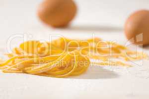 Closeup of uncooked tagliatelle pasta