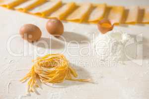 Fresh uncooked tagliatelle pasta over a table