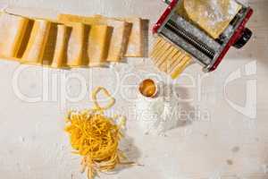 Ingredients for tagliatelle pasta and machine pasta cutter