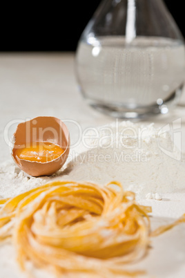 Closeup of Italian tagliatelle pasta and its ingredients