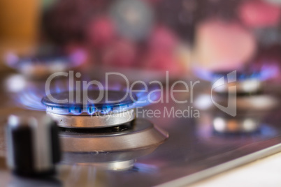 Gas stove with blue flame. Stove with a lit burner