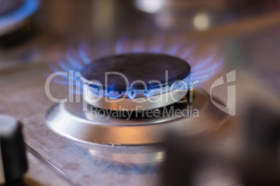 Gas stove with blue flame. Stove with a lit burner