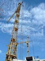 two crane towers on sky background