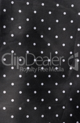 black fabric background with white dots