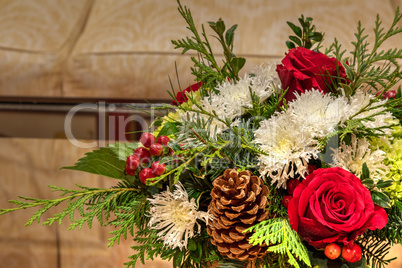 Red and green flowers and pinecones on a Christmas bouquets