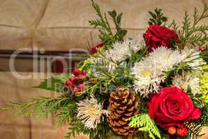 Red and green flowers and pinecones on a Christmas bouquets