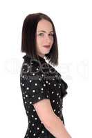 Serious looking pretty woman in a pock dot dress