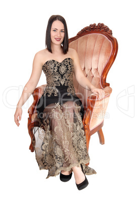 Beautiful woman sitting in armchair smiling