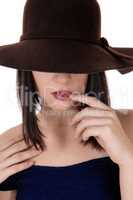 Mysterious woman with big hat in close up
