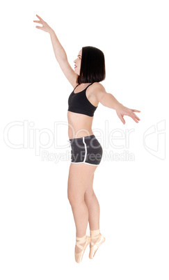 Dancing young woman standing tiptoe