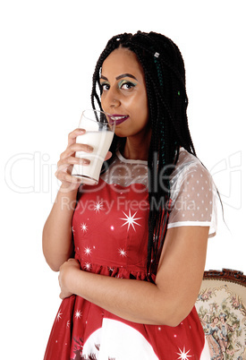 Young woman standing and drinking milk