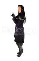 Woman standing in black coat and boots