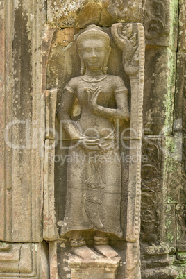 Bas-relief of standing woman in temple wall