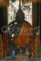 Buddha statue in temple dressed in orange