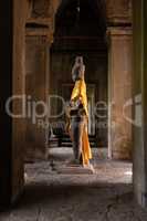 Buddha statue standing in Angkor Wat corridor