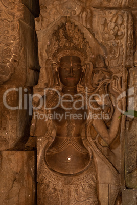 Close-up of goddess carved in temple wall