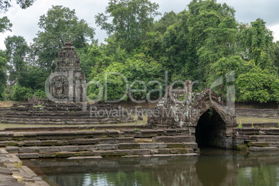 Decorative stone monuments in ponds with trees