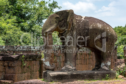 Elephant statue at corner of ruined temple