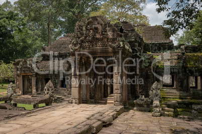 Facade of Banteay Kdei temple in trees