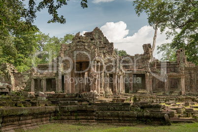 Facade of Preah Khan framed by trees