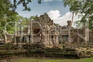 Facade of Preah Khan framed by trees