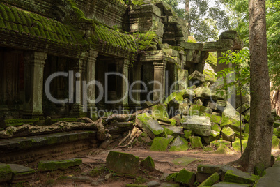 Fallen rocks by colonnade with mossy roof