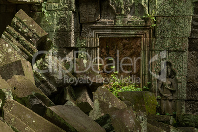 Fallen rocks in sunshine by stone doorway