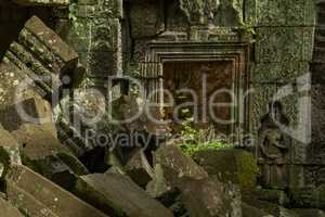 Fallen rocks in sunshine by stone doorway