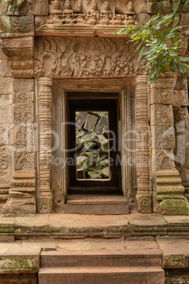 Fallen rocks seen through ruined temple doorway