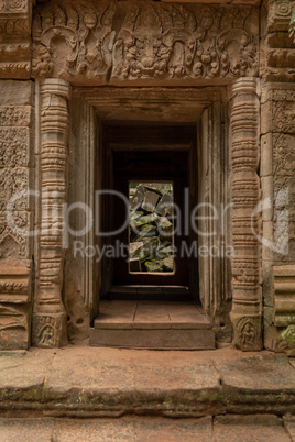 Fallen rocks seen through stone temple entrance