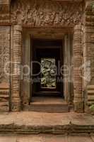 Fallen rocks seen through stone temple entrance