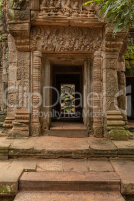 Fallen rocks seen through stone temple doorway