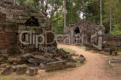 Fallen stone blocks beside stone temple buildings
